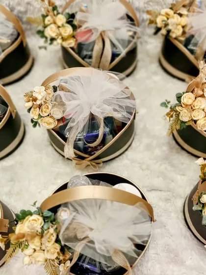 An overhead view of round corporate hampers created for Yes Bank. Each basket is filled with premium products and adorned with floral arrangements, ready to be sent to valued clients.