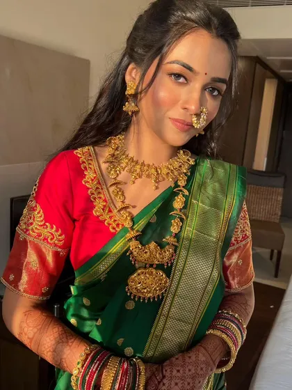 A portrait of the bride, showing how the long, flowing curls beautifully frame her face and complement her traditional jewelry.