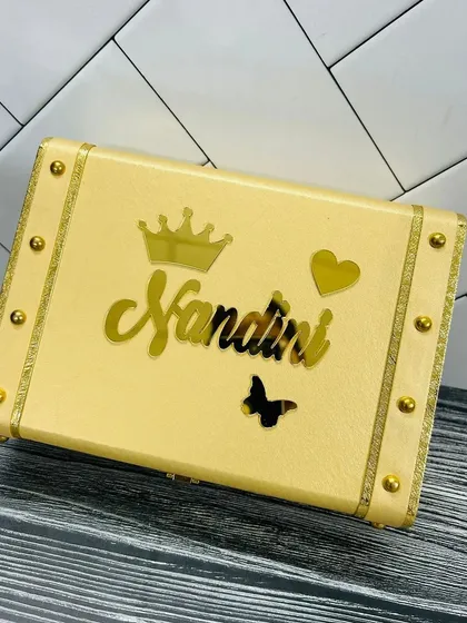 This cream-colored keepsake trunk is another elegant option. It is shown here customized with a name, crown, heart, and butterfly, making it a wonderful personalized gift.