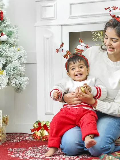 Holiday sessions are a perfect way to capture the festive spirit. This mother and son are enjoying a magical Christmas moment in our studio, complete with a decorated tree and cozy props. These themed shoots make for perfect holiday cards and family keepsakes.