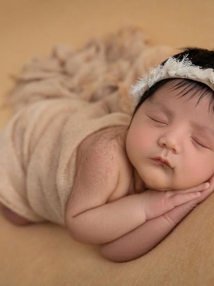 A peaceful side lying pose, perfect for capturing the baby's profile and chubby cheeks.