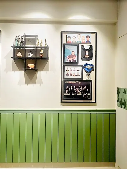 A hallway featuring a wall of memories, with a framed guitar and personal photos, reflecting the homeowner's story.