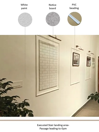 The passage leading to the gym features clean white walls with simple PVC beading to create a paneled effect. This detail adds a touch of classic elegance while keeping the space bright and functional with integrated notice boards.