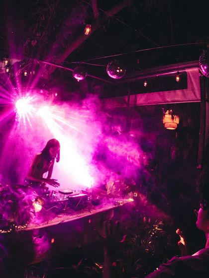 A moment from my birthday party, surrounded by friends in a beautiful outdoor setting. The purple lighting and smoke created a magical, intimate atmosphere.