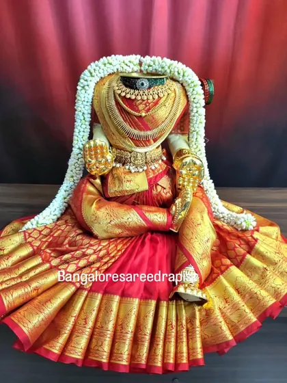 Draping for the Goddess is a service I hold very close to my heart. This Varamahalakshmi drape in red and gold silk showcases the intricate pleating and styling involved in preparing for the festival.