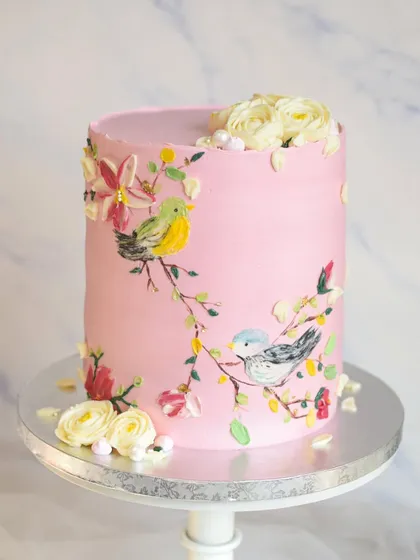 This tall, elegant cake showcases my love for hand-painted details. I used buttercream to paint delicate birds on branches, creating a unique and artistic centerpiece for a special 60th birthday celebration.