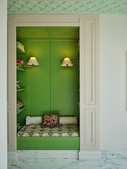 A direct view into the cozy reading nook. Framed by classic paneling, the built-in bench and shelving create a perfect spot for pause, embodying our philosophy of designing for quiet, everyday rituals.