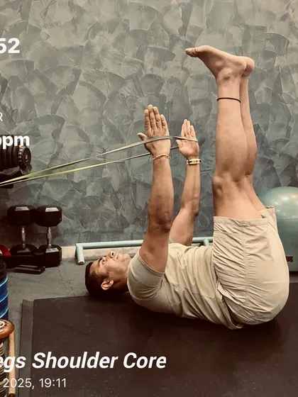 Tiredness is just a state of mind. A snapshot from a legs, shoulder, and core session, using a resistance band for a dead bug variation to enhance core engagement and shoulder stability.