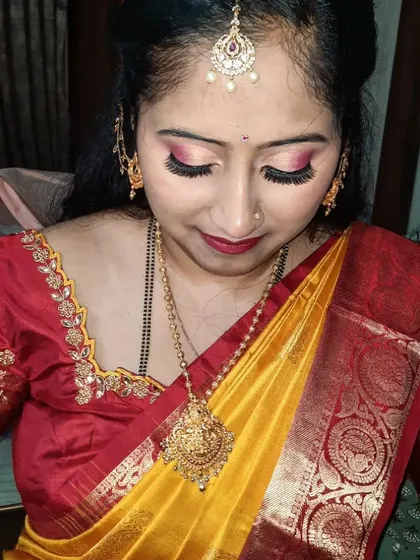 A close-up on the eye makeup for this naming ceremony look. I used warm, coppery tones with a touch of shimmer to make her eyes stand out.