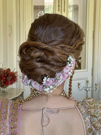 A detailed back view of the messy bun, showing the placement of the flowers to create a crescent shape.