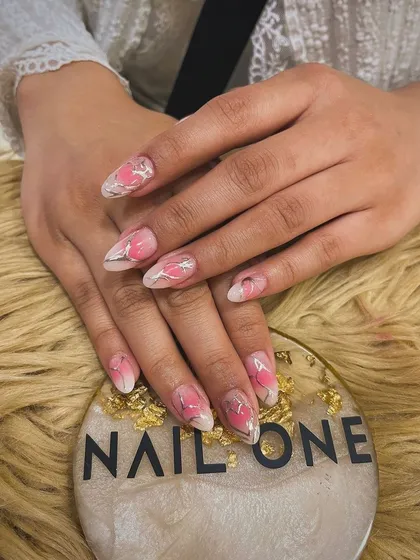 A full view of the delicate pink watercolor floral nails. This artistic style creates a soft, blended effect that is both unique and beautiful.