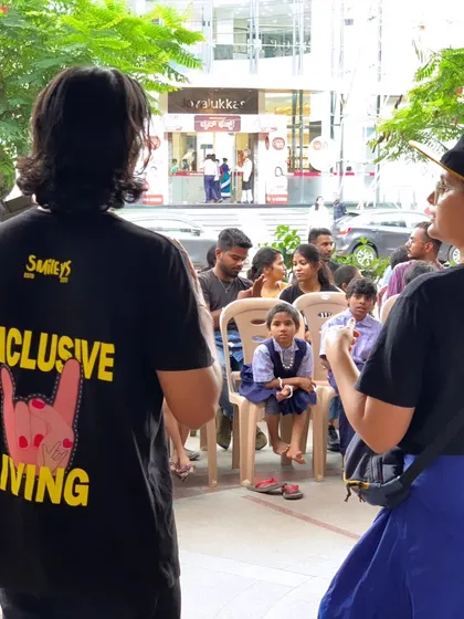 A volunteer wearing our "Inclusive Living" t-shirt at Sign Fest. This message is at the core of everything we do, from our workshops to our large scale festivals.