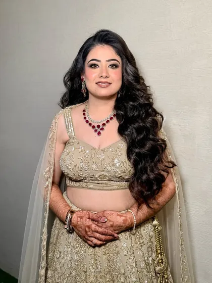 The complete look. The makeup is glamorous yet elegant, perfect for a modern engagement ceremony.