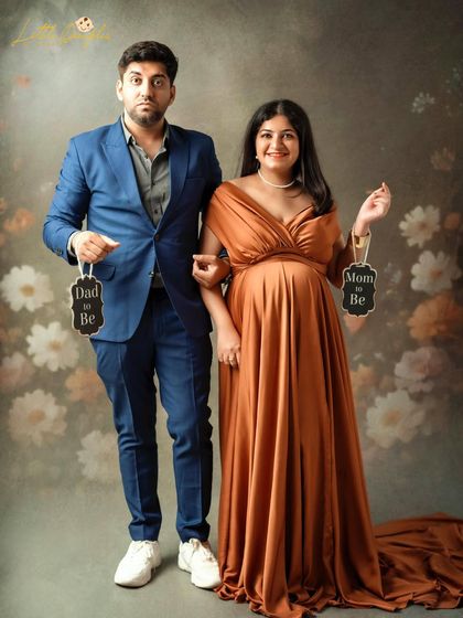 "Mom to Be" and "Dad to Be" signs are a fun way to announce your excitement. This couple's playful expressions make the shot even more special.