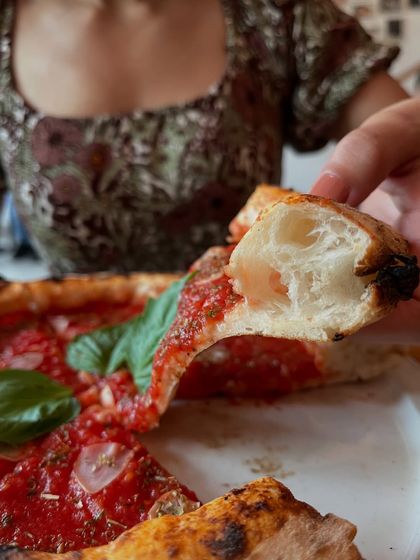 Simplicity at its best. A slice of our Marinara pizza, showing off the light and airy crust.
