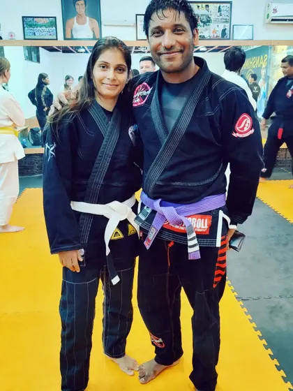 Posing with another skilled martial artist on the mats. Training in Jiu-Jitsu brings together people from all walks of life, united by their dedication to the art.