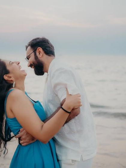 The wind in her hair and a huge smile on her face. This is the kind of authentic, joyful interaction I love to photograph during a relaxed beach couple shoot.