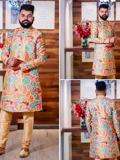 Make a bold statement with vibrant prints. This multi-colored paisley print sherwani is for the man who isn't afraid to stand out. It's a fun, festive choice for wedding guests or any celebration.