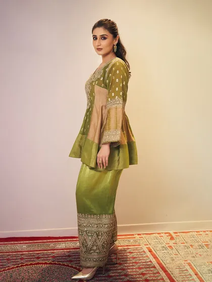 For a cultural collaboration event, we chose this regal olive green peplum and sharara set by Heena Kochhar for Dhvani Bhanushali. The bell sleeves and detailed embroidery add a touch of royalty.
