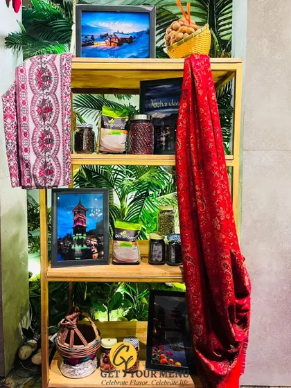 A themed decor shelf for a regional cuisine station, using fabrics, photos, and spices to create an authentic and immersive atmosphere.