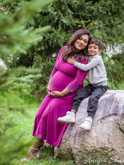 A loving portrait of a mother-to-be and her son. The way he hugs her and her serene smile beautifully illustrates the growing family's bond.