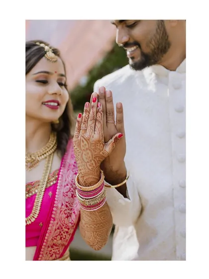 A creative shot focusing on the bride and groom's hands, showcasing the intricate henna and the newly exchanged rings.