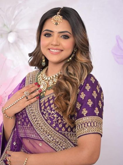 The bride looks radiant with her soft curls and beautiful smile. This is a timeless and elegant choice.