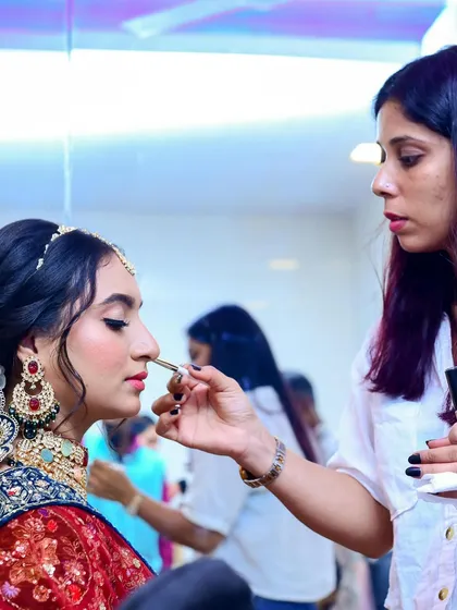 A behind-the-scenes shot of me giving the final touches to the bride's makeup.