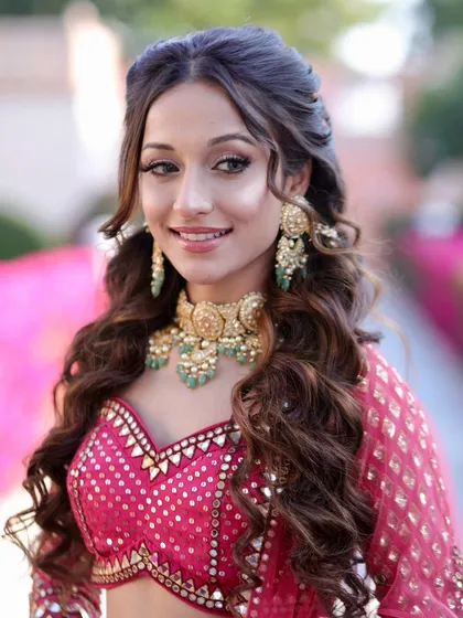 Another beautiful shot of the Bhaat ceremony look. The half-up hairstyle with soft waves is both elegant and practical for a daytime event.