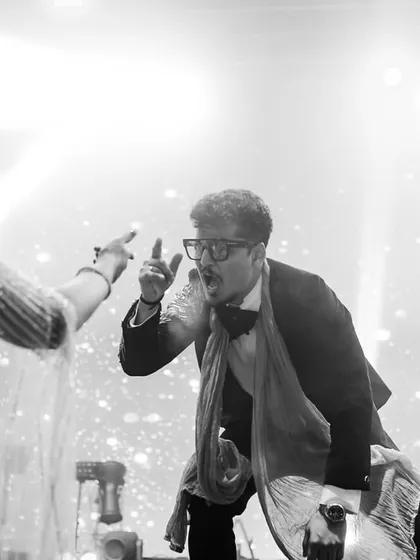 A black and white shot capturing a dramatic, funny moment in a group performance.