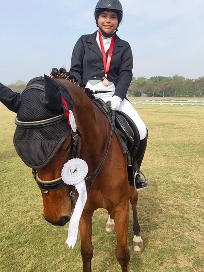 One of our talented riders posing with her horse after a successful event at the Delhi Horse Show 2024. The bond between horse and rider is key to our success.