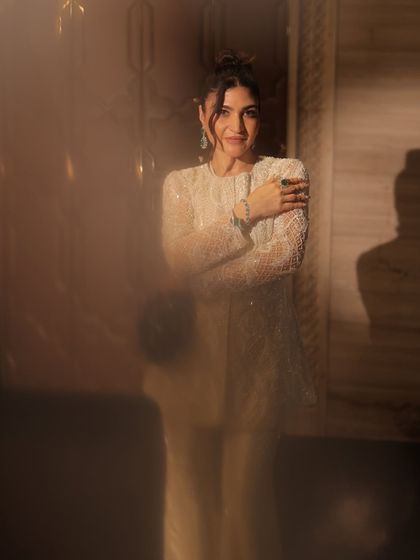 An artistic shot with a soft focus, creating a dreamy and ethereal vibe. The makeup remains flawless and elegant.