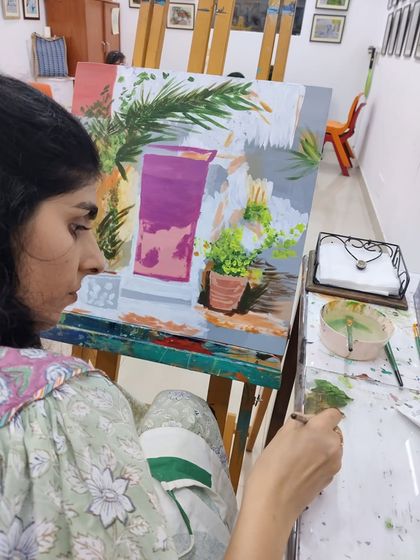 This series captures an adult student working on two different acrylic paintings, one a floral doorway and the other an abstract piece, showing the variety of styles we teach.