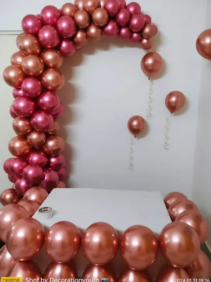 A chrome rose gold balloon arch. This setup is perfect for framing a cake table or creating a stylish entrance, adding a touch of modern elegance to the party.