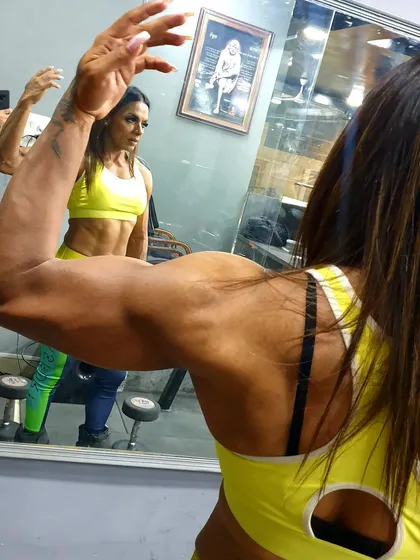 Checking my bicep development in the mirror. Constant self-assessment is part of the process to ensure every muscle group is balanced.