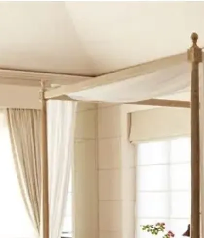 A detail of the four-poster bed from our Goa villa project. The sheer white drapes create a dreamy, ethereal effect, softening the wooden frame and adding a touch of romance to the bedroom.