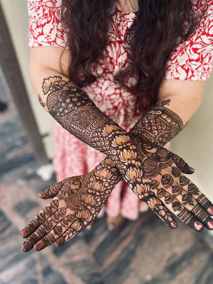 A beautiful design with a focus on lotus flowers and peacock feathers, creating a flowing and organic pattern.