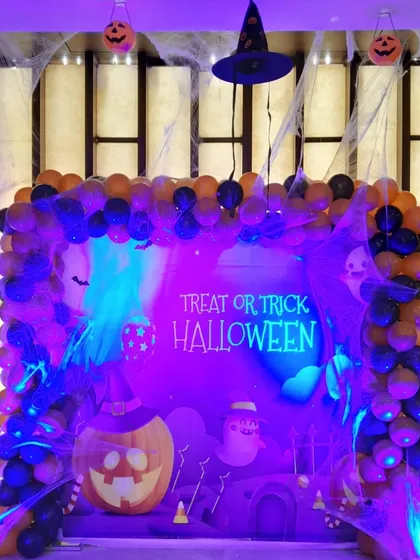 The same Halloween setup viewed under different lighting, showing how I use spotlights to create a spookier, more atmospheric vibe for the event.