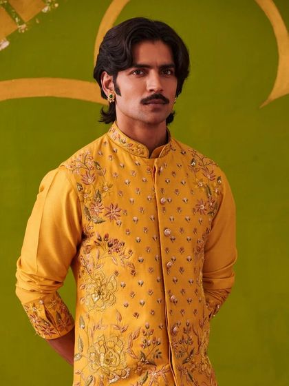 A portrait of the model in the yellow kurta set, showcasing the fine embroidery and the confident attitude the outfit inspires.