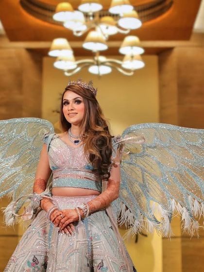 A full length portrait of the bride in her unique angel wing lehenga. We love to showcase bold and creative bridal fashion choices.