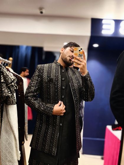 A full-view mirror selfie showcasing the modern, stylish black and silver embroidered Indo-western outfit.