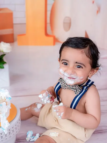 The pure delight of a cake smash. This close-up captures the messy face and happy smile that define this fun-filled session.