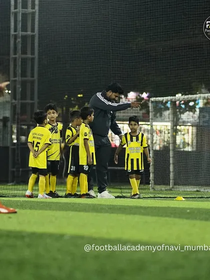 A coach directs players during a drill, teaching them about positioning and movement.
