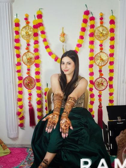 Another shot of a happy bride posing with her full bridal mehndi, ready for her wedding festivities.