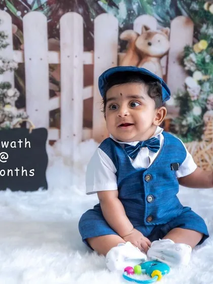 Look who's sitting up. Our 7-month milestone sessions are perfect for capturing this big achievement with fun, themed studio setups and adorable outfits.