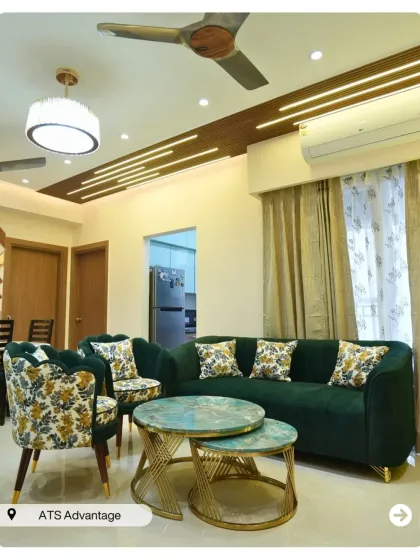 A different angle of this elegant living room, showcasing the nested coffee tables with green agate-like tops and the beautiful floral accent chairs.