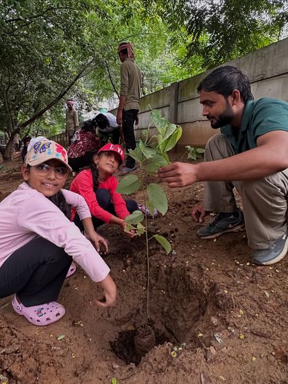 The next generation of eco-warriors. Children join our team to plant a native sapling at Aravali Creek, learning about environmental stewardship from a young age.
