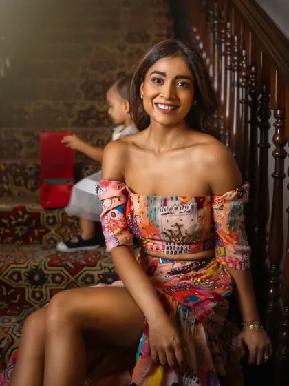 A candid moment during my shoot with Shriya Saran, as her daughter Radha plays behind her. Shriya's comment about being a working mother adds a layer of authenticity to this beautiful portrait, capturing the reality of balancing career and motherhood.
