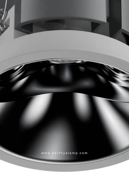 This downlight features a highly polished chrome reflector. The metallic surface creates a bright, crisp light with a distinctive pattern, adding a dynamic and modern touch to the illumination of a room.