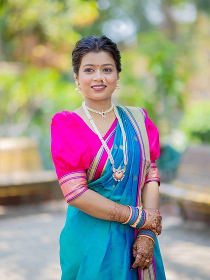 This bride looks serene and beautiful in her soft textured hairstyle and traditionally draped Nauvari saree. The style is perfect for pre-wedding functions or for a bride who prefers a subtle look.